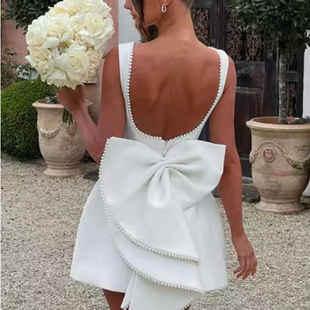 Elegant White Pearl-Trim Backbow Mini Dress